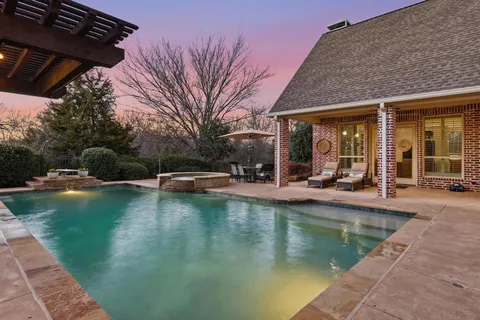 a view of a swimming pool with outdoor seating