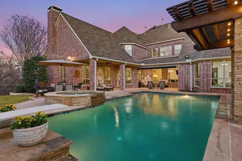 a view of a swimming pool with outdoor seating and a potted plant