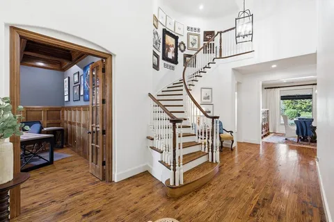 a view of entryway livingroom and hall with wooden floor