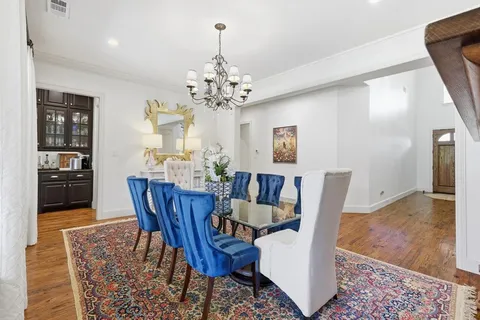 a view of a dining room with furniture and chandelier