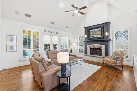 a living room with furniture a window and a fireplace