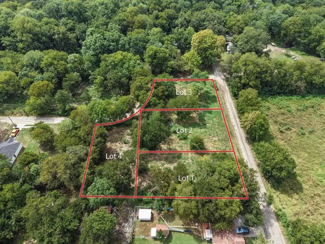 an aerial view of residential house with outdoor space and trees all around