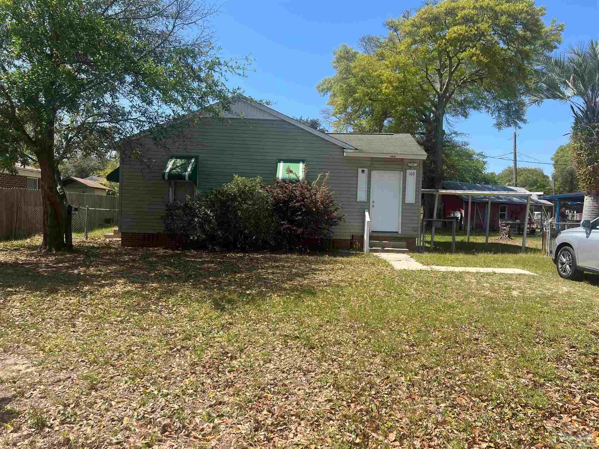 a view of a house with a yard and tree s