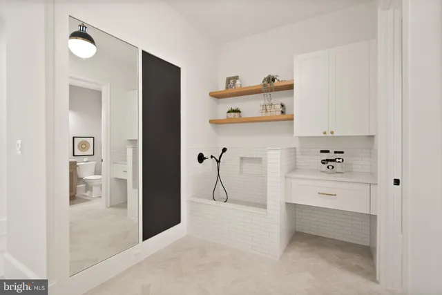 a bathroom with double sink and a mirror