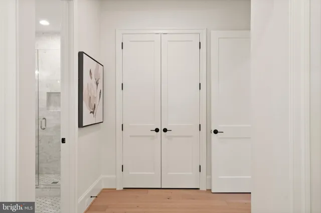 a kitchen with a sink dishwasher and a stove with wooden floor