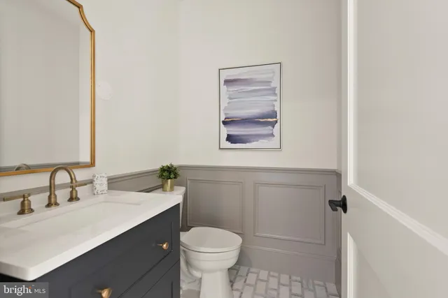 a bathroom with a sink toilet vanity and shower