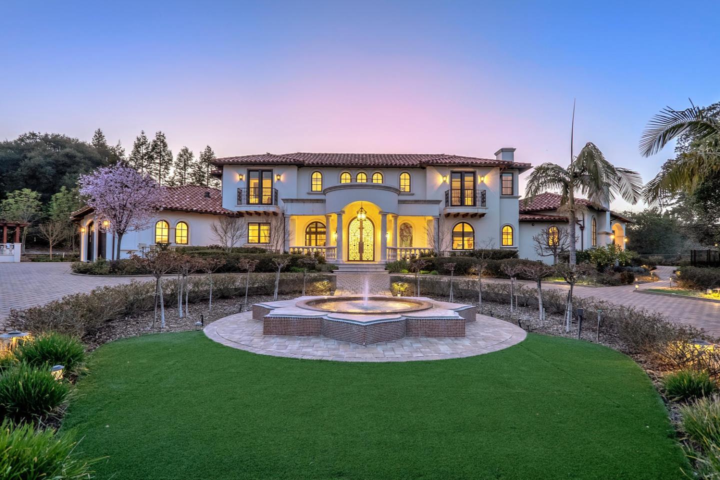 a front view of a house with a garden and sitting area