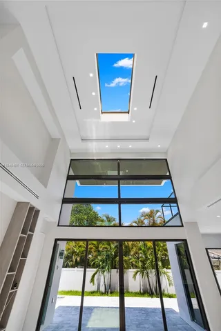 a large white kitchen with a large window