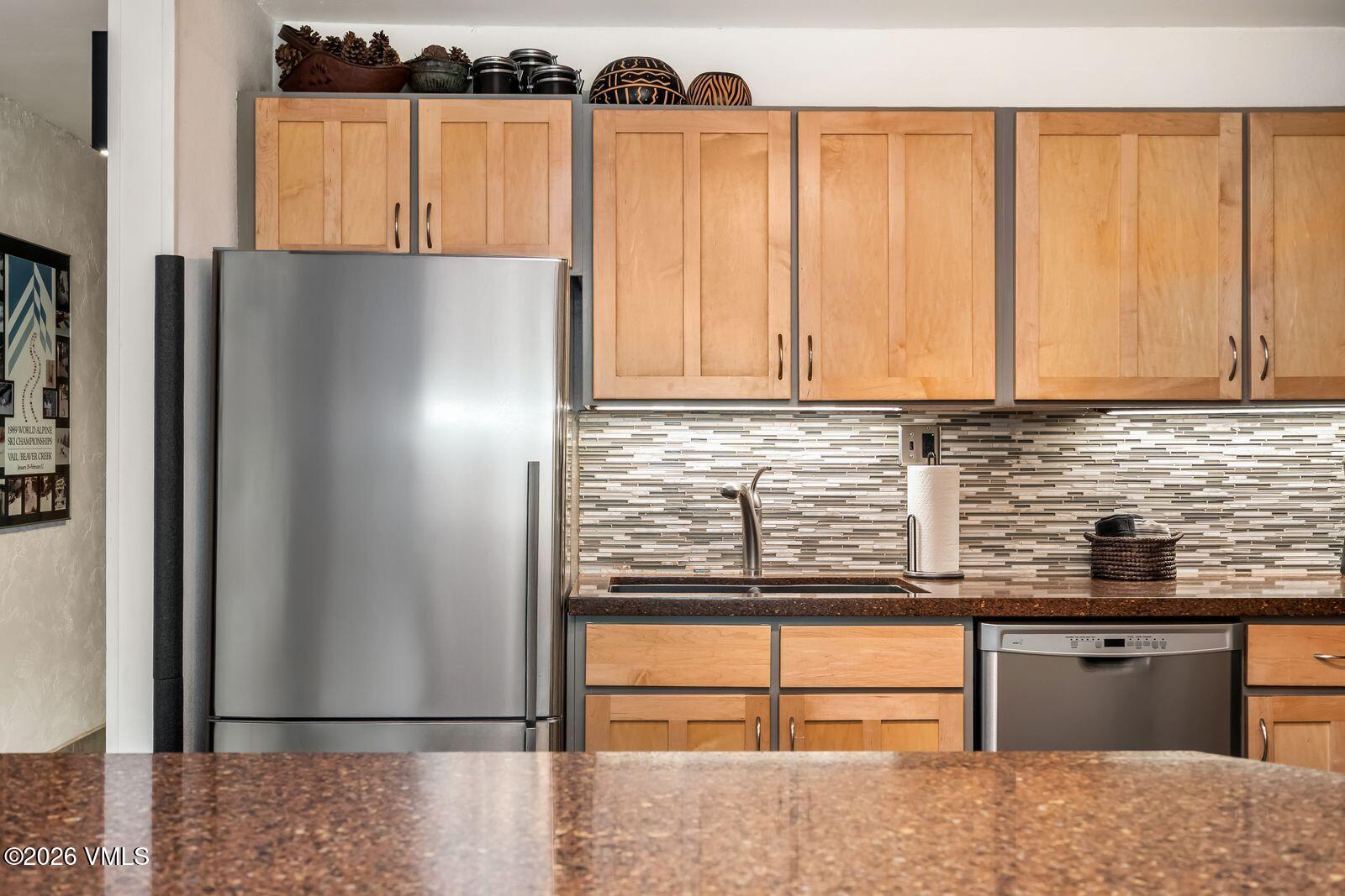 500 South Frontage Road East, Unit 308 Vail, CO 81657 - Photo 10 of 25 a kitchen with stainless steel appliances granite countertop a refrigerator and a sink