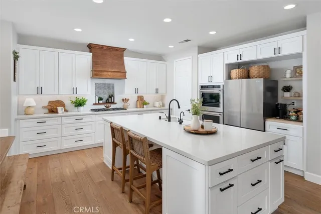 a kitchen with stainless steel appliances kitchen island granite countertop a sink and cabinets