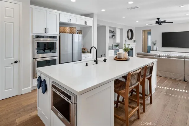 a kitchen with a stove a sink and a refrigerator