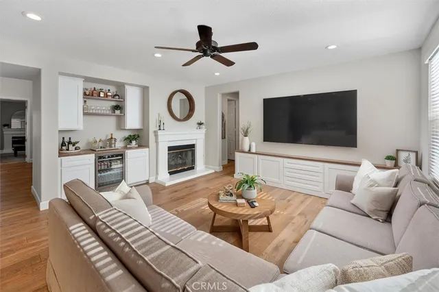 a living room with furniture a flat screen tv and a large window