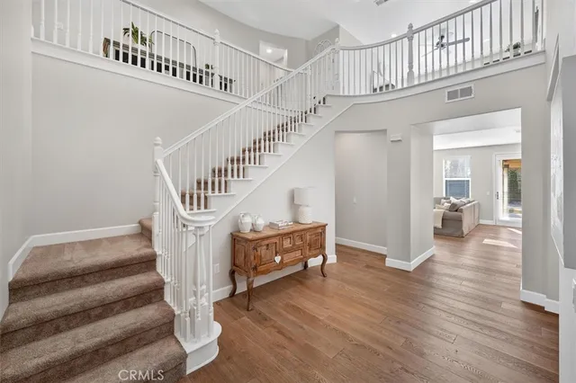 a view of entryway with wooden floor and a front door