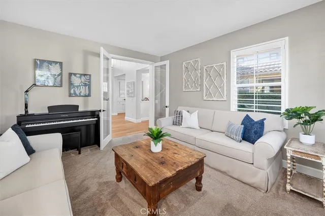 a living room with furniture and a potted plant