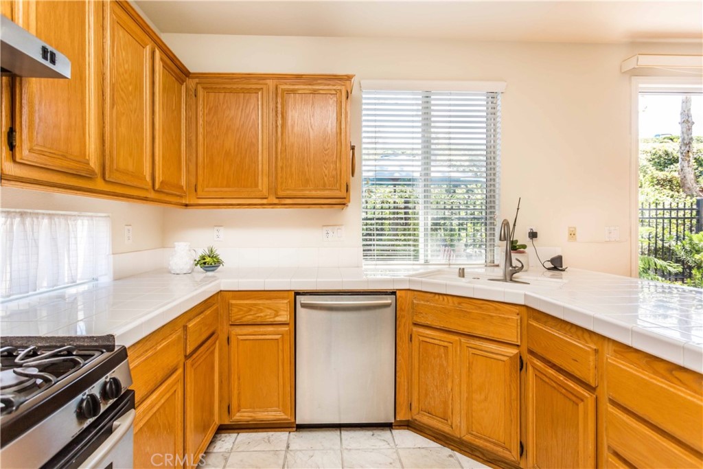 111 Colony Way Aliso Viejo, CA 92656 - Photo 13 of 29 a kitchen with stainless steel appliances granite countertop a sink and a white cabinets