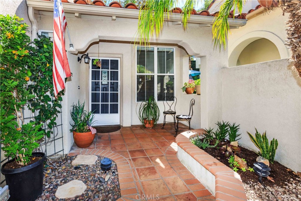 111 Colony Way Aliso Viejo, CA 92656 - Photo 2 of 29 a front view of a house with outdoor seating and potted plants
