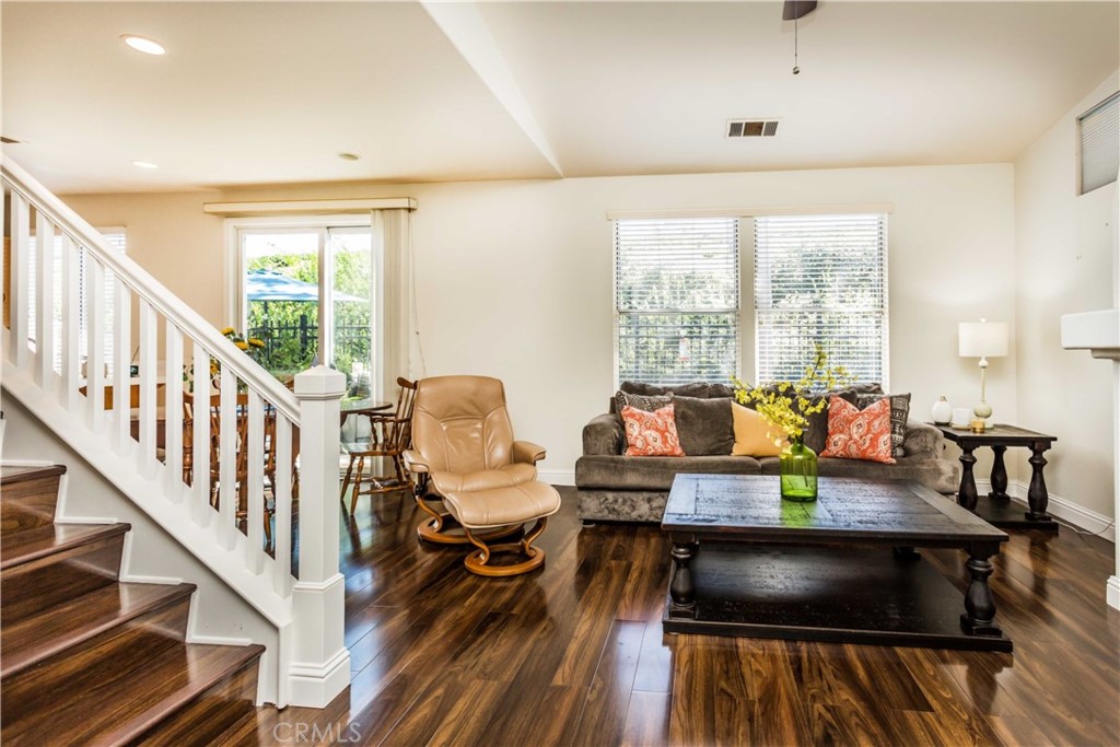 111 Colony Way Aliso Viejo, CA 92656 - Photo 3 of 29 a living room with furniture and a dining table with wooden floor