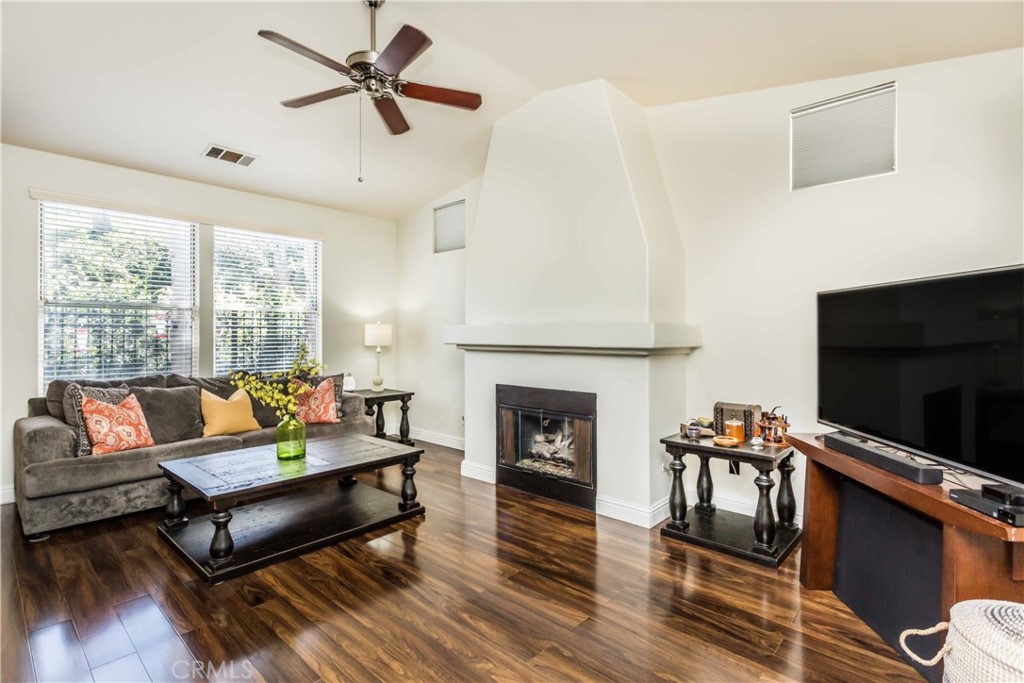 111 Colony Way Aliso Viejo, CA 92656 - Photo 5 of 29 a living room with furniture a flat screen tv and a fireplace