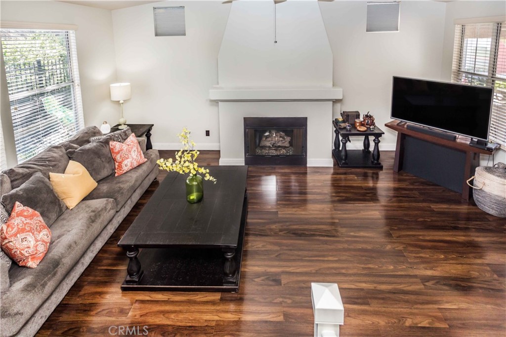 111 Colony Way Aliso Viejo, CA 92656 - Photo 6 of 29 a living room with furniture a fireplace and a flat screen tv