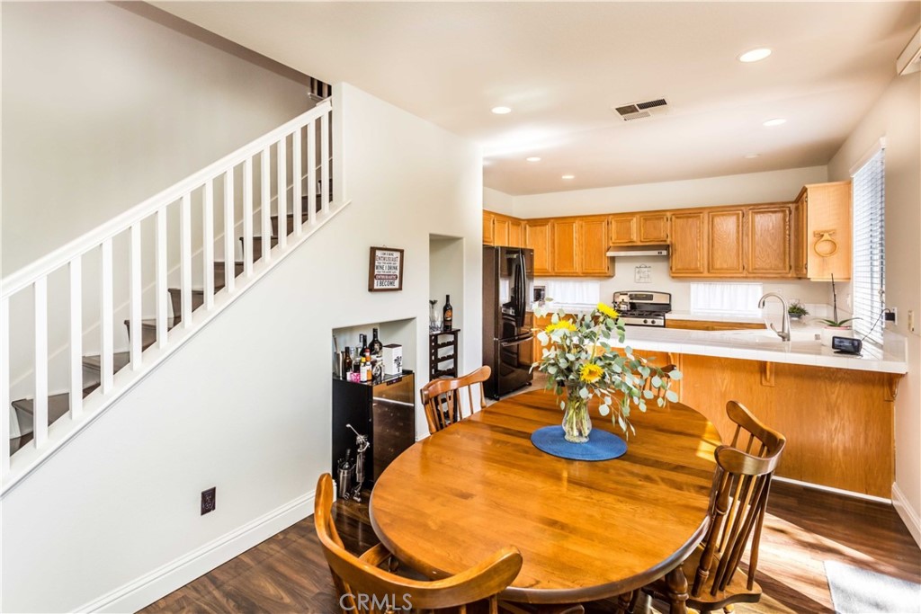 111 Colony Way Aliso Viejo, CA 92656 - Photo 9 of 29 a view of a dining room and a kitchen with furniture window and wooden floor