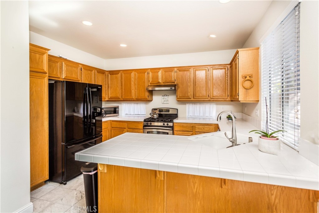 111 Colony Way Aliso Viejo, CA 92656 - Photo 10 of 29 a kitchen with a refrigerator and a sink