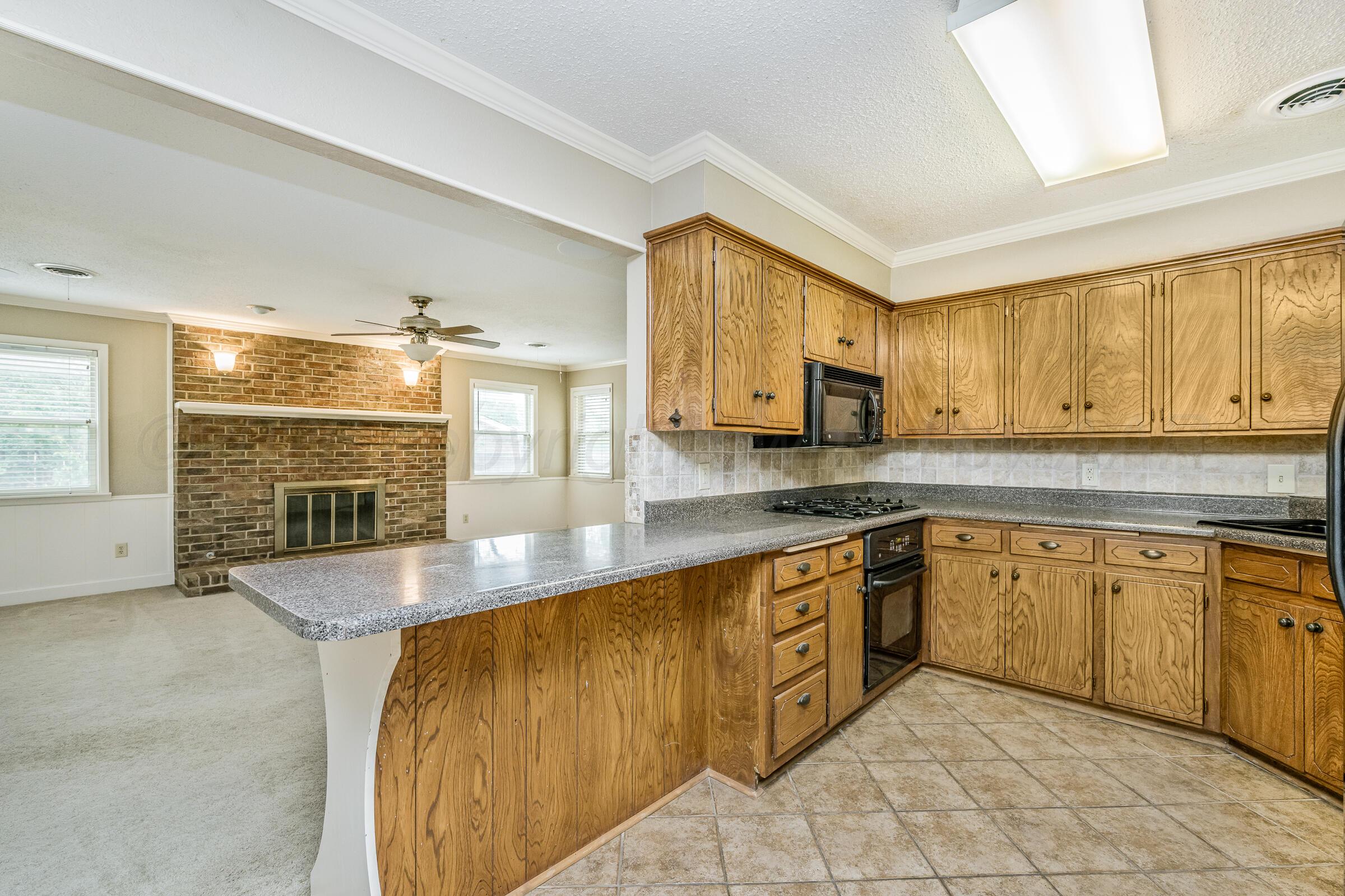 4400 West Farmers Avenue Amarillo, TX 79110 - Photo 11 of 27 a large kitchen with stainless steel appliances granite countertop a sink and cabinets