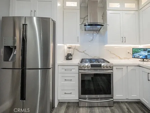 a kitchen with refrigerator a stove and cabinets