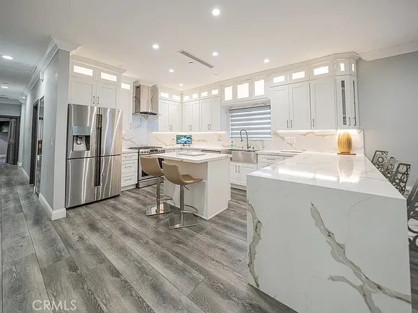 a kitchen with a sink appliances and cabinets