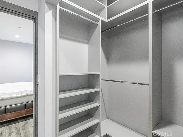 a view of walk in closet with empty racks