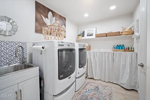 a view of a hallway with washer and dryer