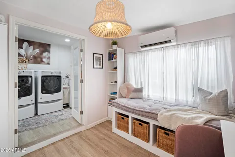 a spacious bedroom with a bed and a chandelier