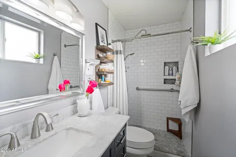 a bathroom with a sink toilet and shower