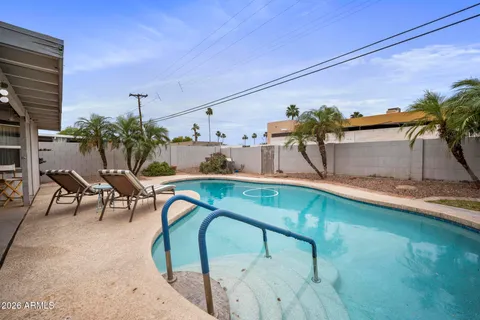 a swimming pool with outdoor seating and yard