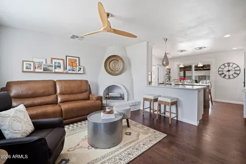 a living room with furniture and a clock