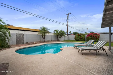 a view of swimming pool with outdoor seating
