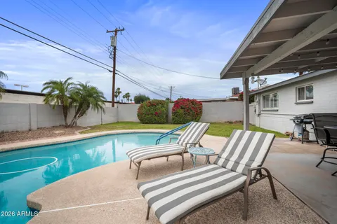 a view of an outdoor dining space with a table and chairs