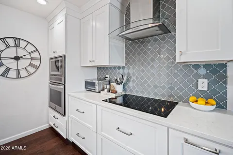 a kitchen with stainless steel appliances granite countertop a sink a stove a microwave and cabinets