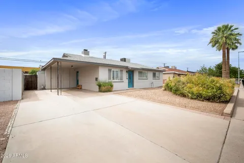 a front view of a house with a garden and entryway