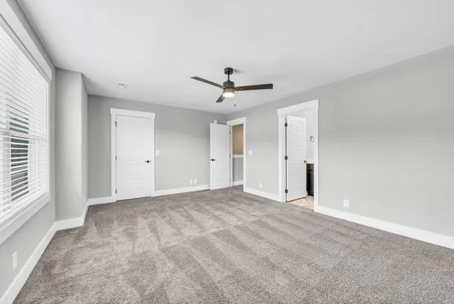 wooden floor in an empty room with a ceiling fan