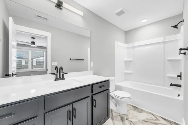 a bathroom with a sink a toilet and a bathtub