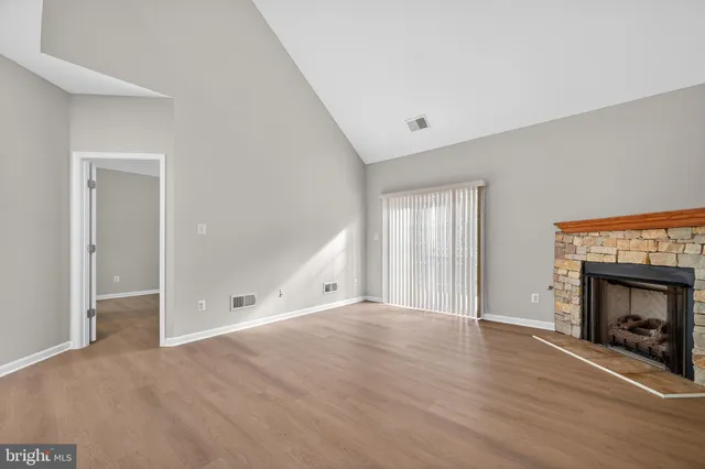 a view of an empty room and a fireplace