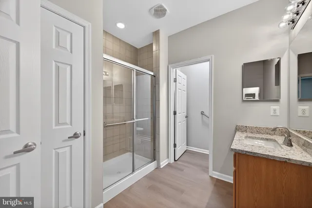 a bathroom with a sink a mirror and a shower