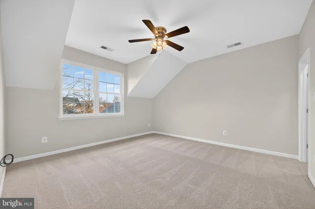 a hallway with wooden floor and a carpet