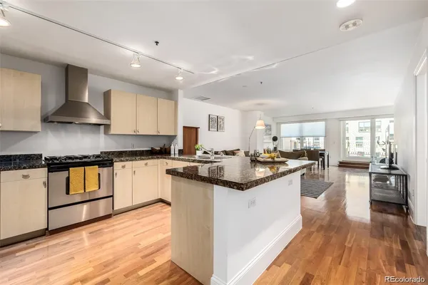 a large kitchen with stainless steel appliances granite countertop a stove and a sink