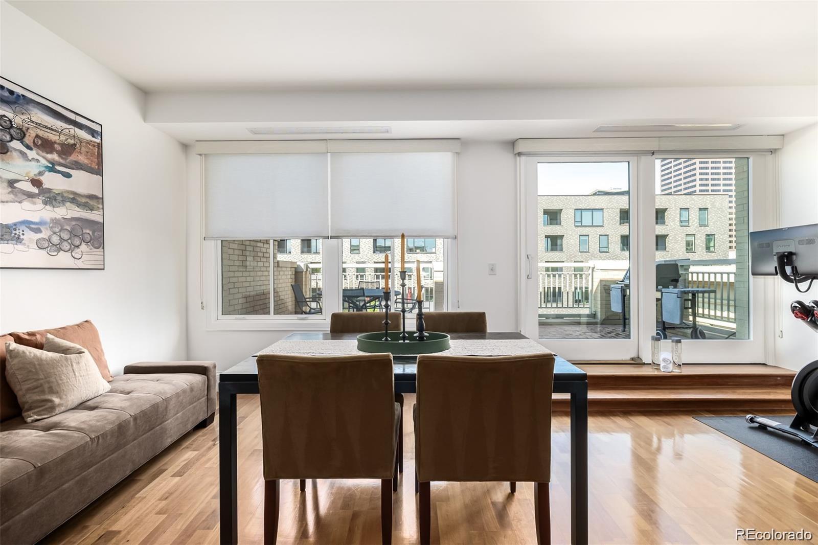 1560 Blake Street, Unit 810 Denver, CO 80202 - Photo 13 of 48 a view of a dining room with furniture and windows
