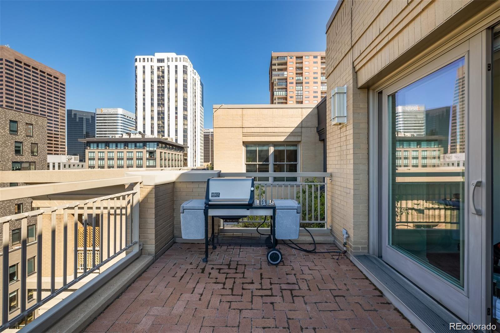 1560 Blake Street, Unit 810 Denver, CO 80202 - Photo 2 of 48 a view of a chairs and a table in the balcony