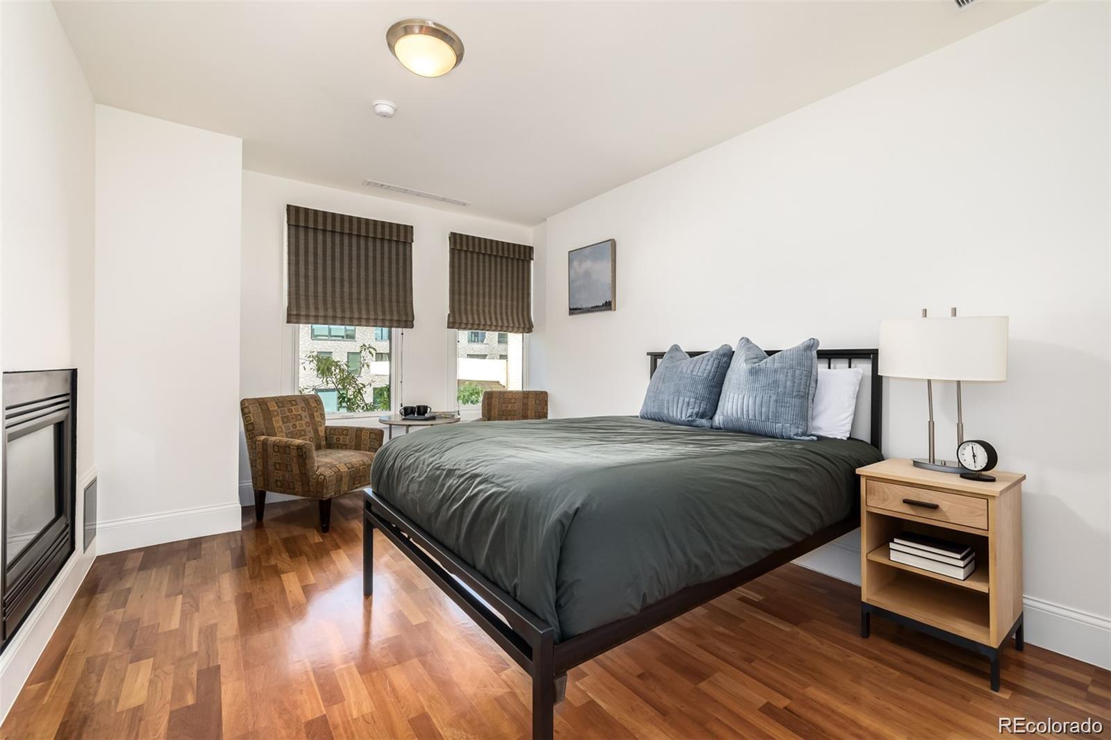 1560 Blake Street, Unit 810 Denver, CO 80202 - Photo 23 of 48 a bedroom with a bed and a table
