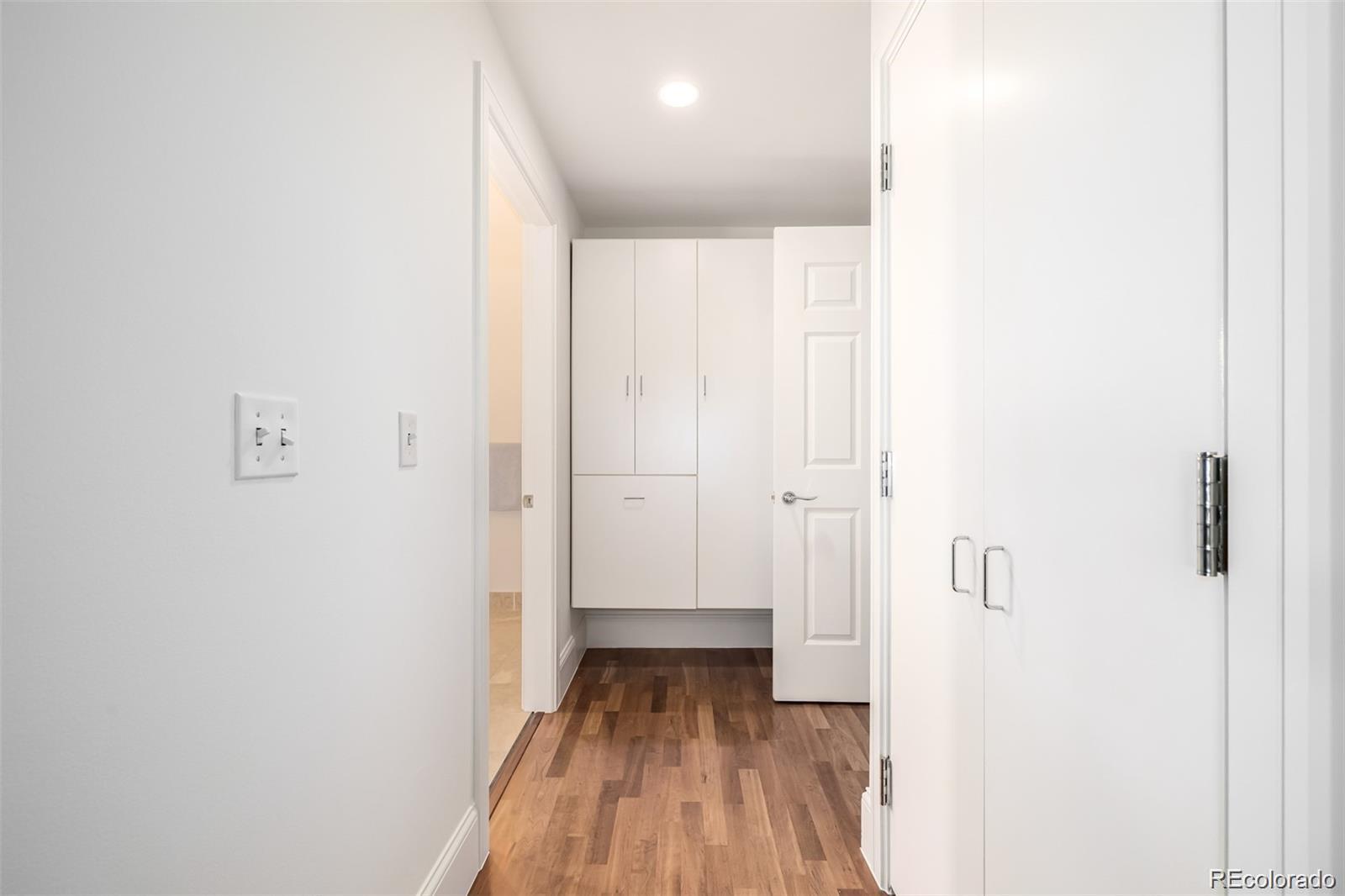 1560 Blake Street, Unit 810 Denver, CO 80202 - Photo 27 of 48 a view of a hallway with wooden floor