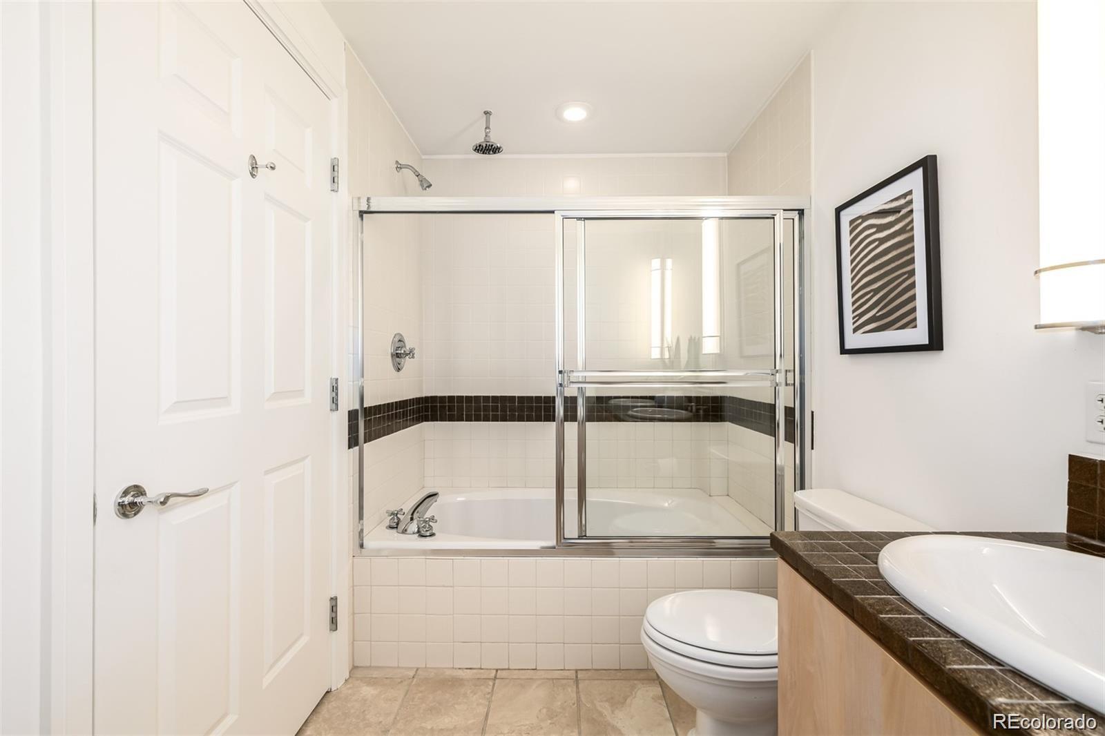 1560 Blake Street, Unit 810 Denver, CO 80202 - Photo 30 of 48 a bathroom with a sink toilet and shower