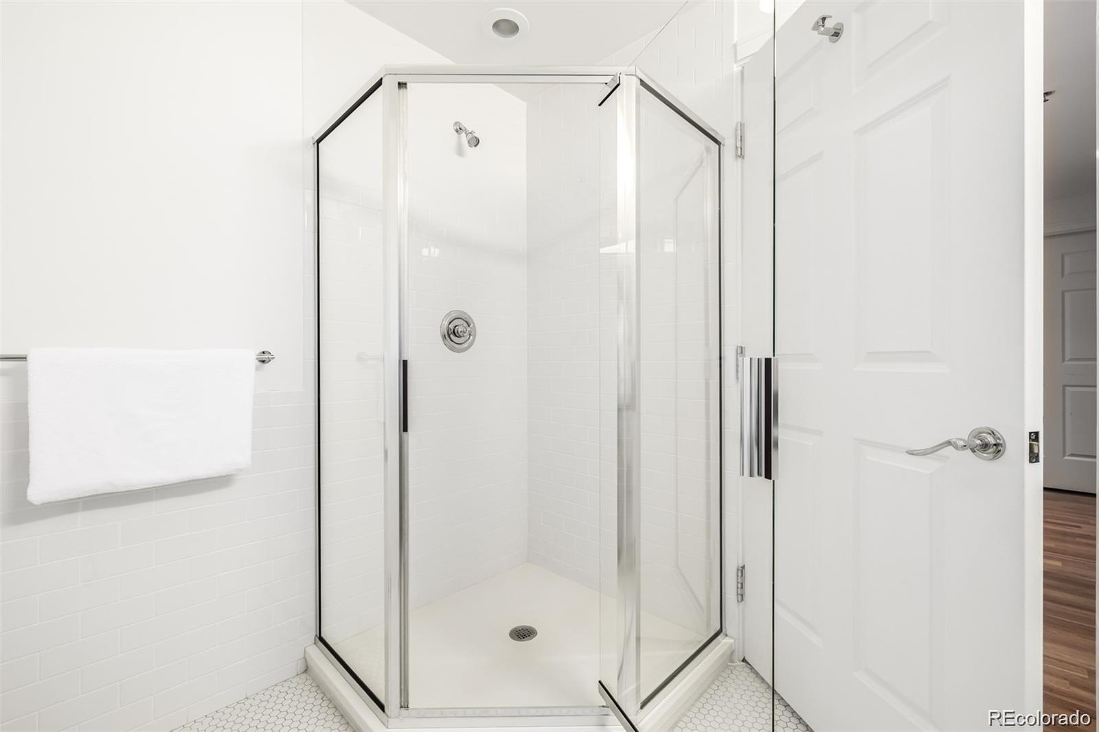 1560 Blake Street, Unit 810 Denver, CO 80202 - Photo 36 of 48 a bathroom with a glass shower door